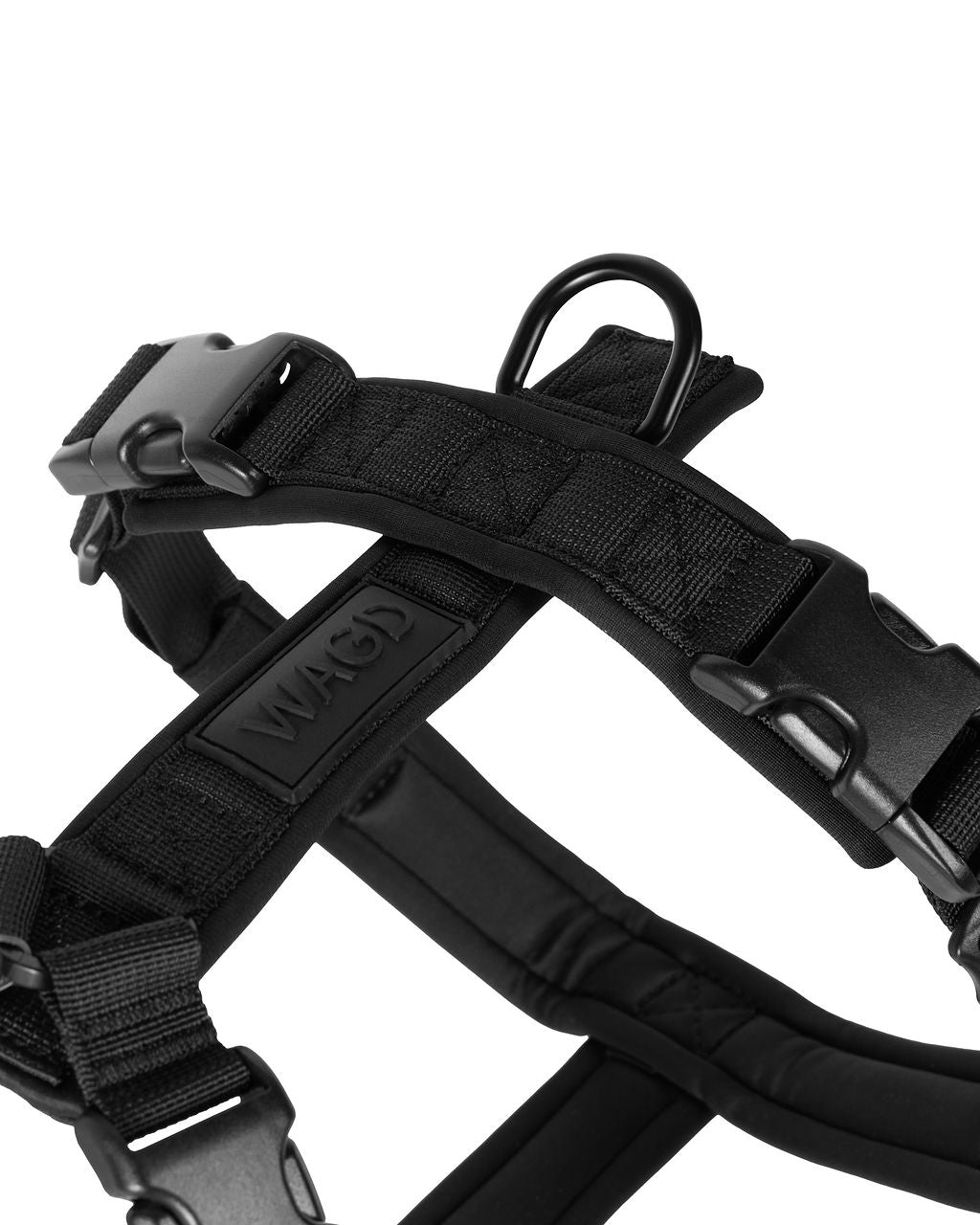Black dog harness with visible brand logo on a white background