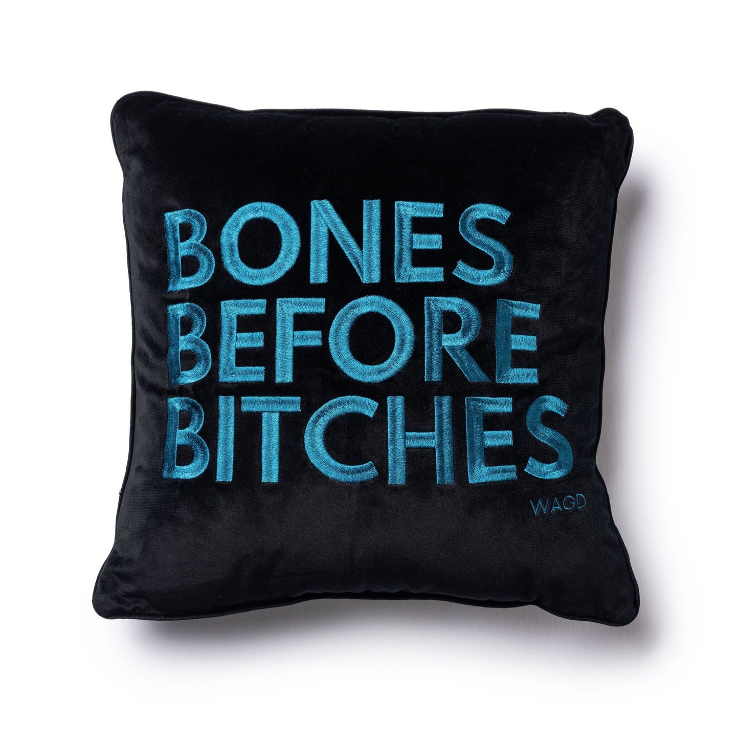 velvet square pillow with Bones Before Bitches embroidered on to it. Black base with peacock embroidery.