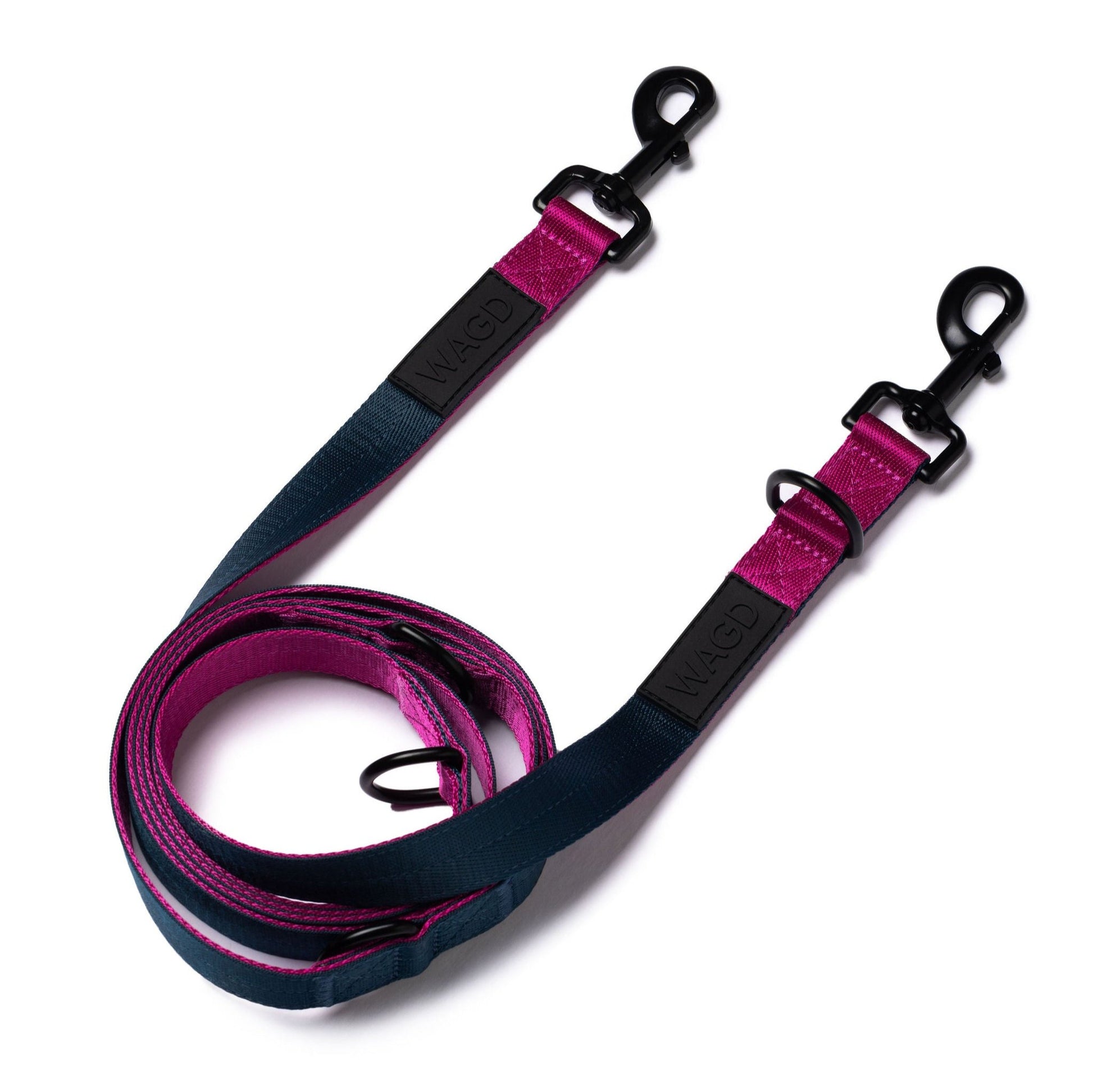 Hands free, multi length lead in Peacock and Pink with 2 black metal clips at either end and with WAGD rubber logo. Rolled up and laid flat.