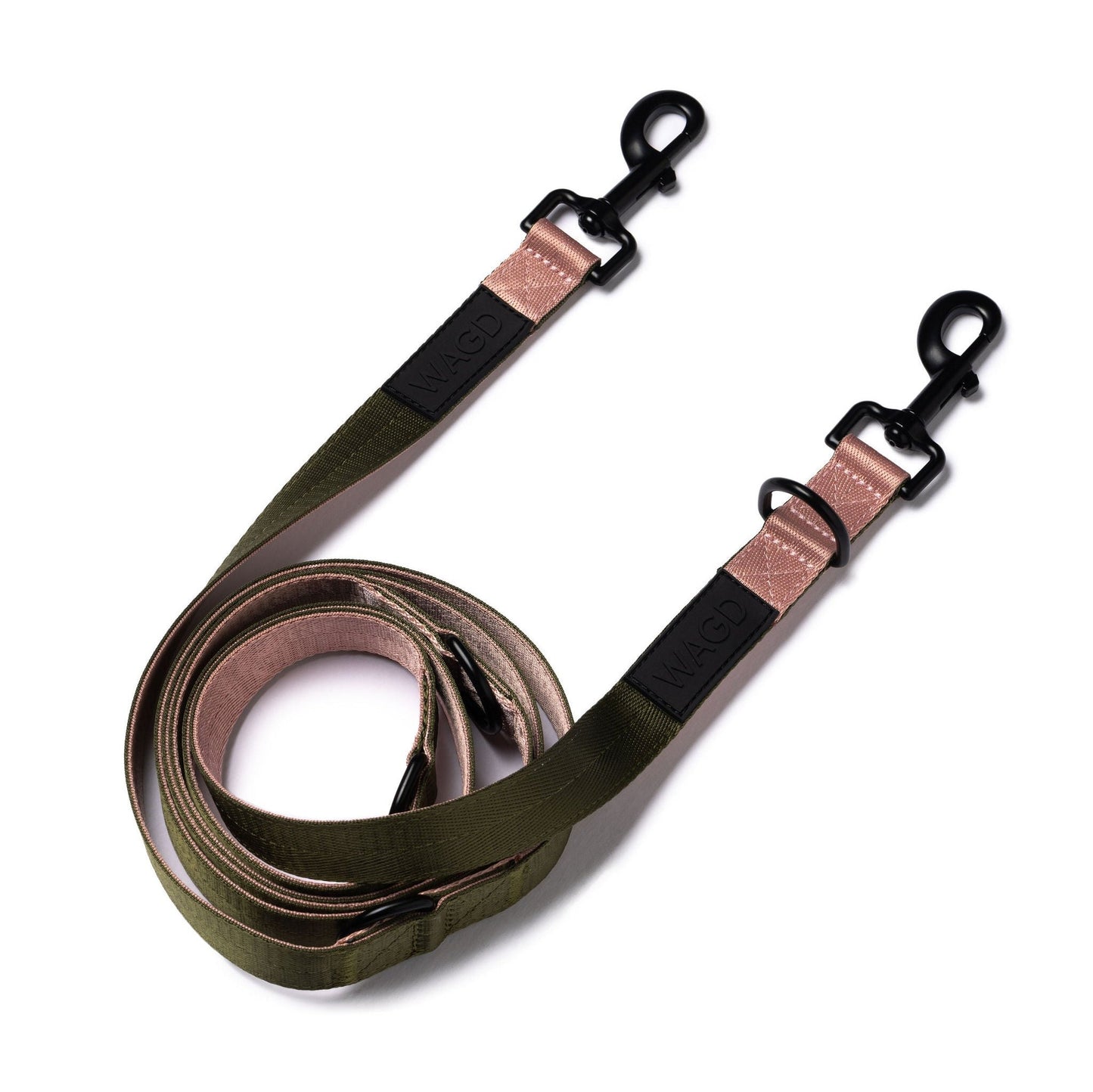 Hands free, multi length lead in Olive and Rose with 2 black metal clips at either end and with WAGD rubber logo, rolled up and laid flat.