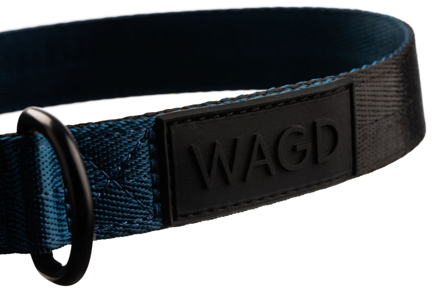 Close up of collar logo. Black rubber with raised black letter WAGD.