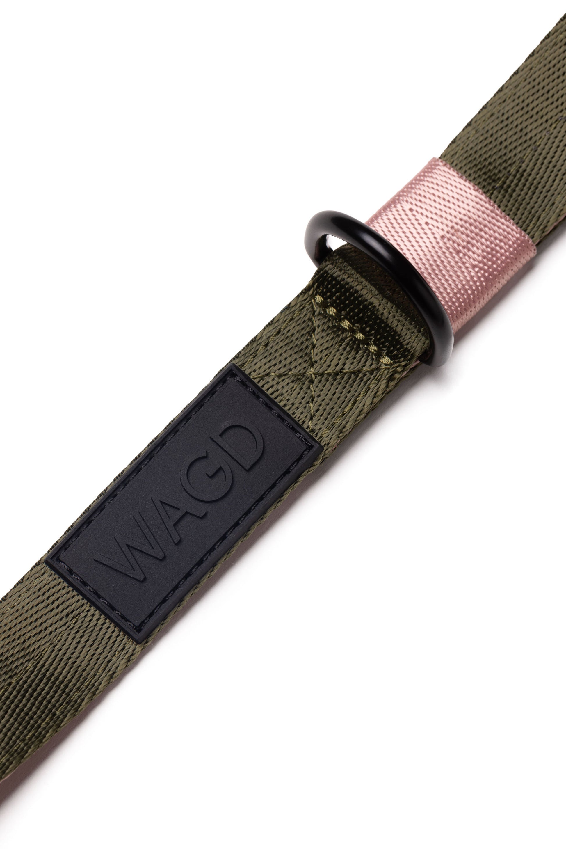 Close up of black rubber WAGD logo on an olive and pink dog lead, under the handle.